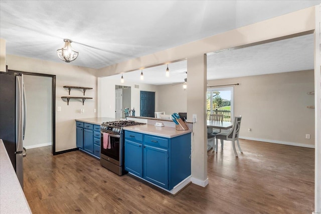 kitchen with light countertops, appliances with stainless steel finishes, dark wood-type flooring, and blue cabinets