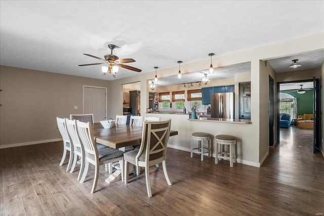 dining room featuring baseboards, wood finished floors, a wealth of natural light, and ceiling fan