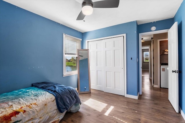 bedroom with baseboards, wood finished floors, a closet, and ceiling fan