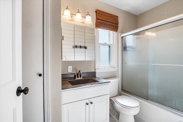 full bath with enclosed tub / shower combo, toilet, and vanity