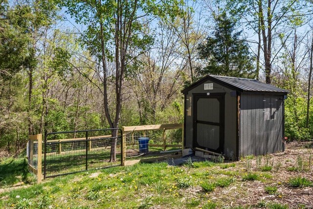 view of shed featuring fence