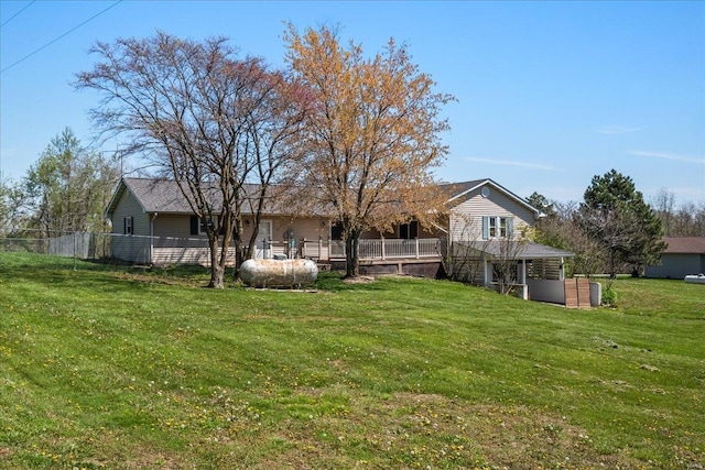 view of yard with fence and a wooden deck