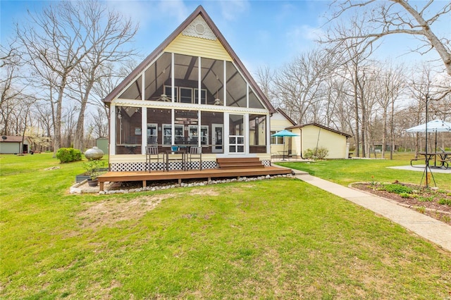 back of property with a sunroom and a lawn