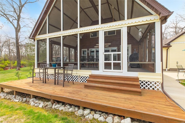 wooden deck featuring a sunroom