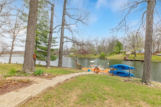 view of dock featuring a water view and a yard