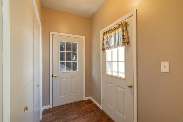 entryway featuring dark wood-style flooring and baseboards