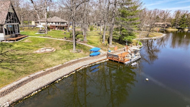 dock area with a water view and a lawn