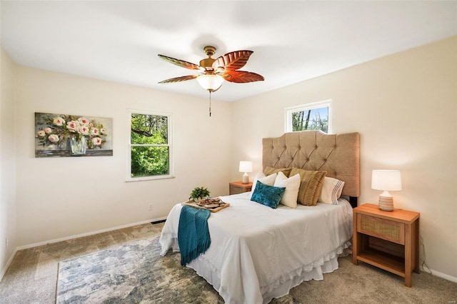 bedroom featuring light colored carpet, baseboards, and multiple windows
