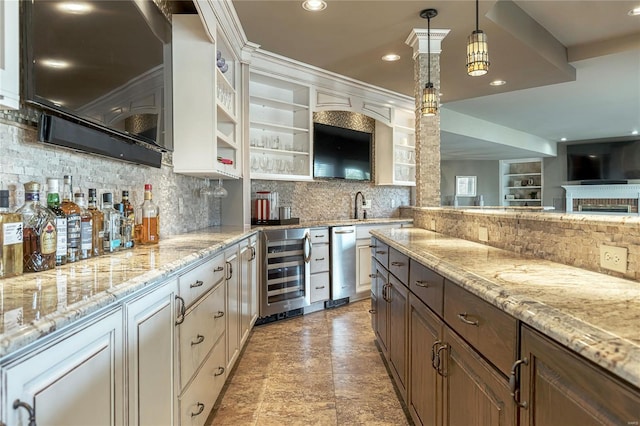 kitchen featuring wine cooler, decorative backsplash, and light stone countertops