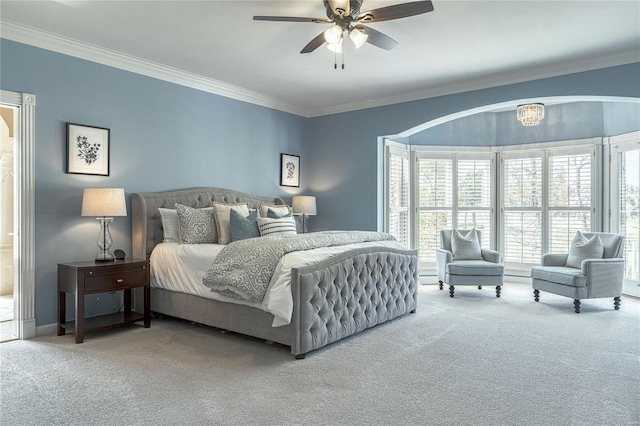 carpeted bedroom with crown molding and a ceiling fan