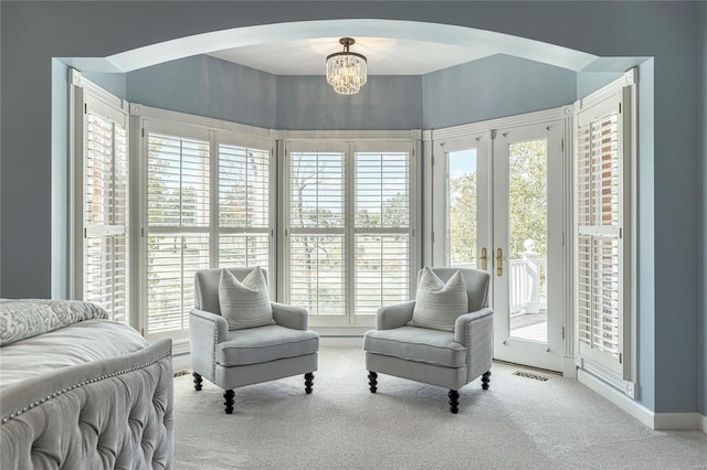 interior space featuring carpet flooring, arched walkways, and plenty of natural light