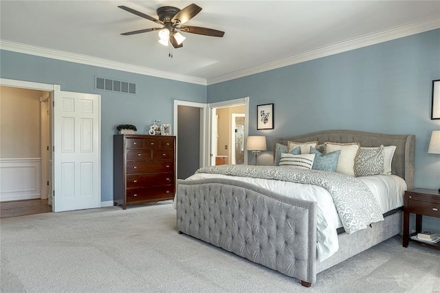 carpeted bedroom with ceiling fan, visible vents, and ornamental molding