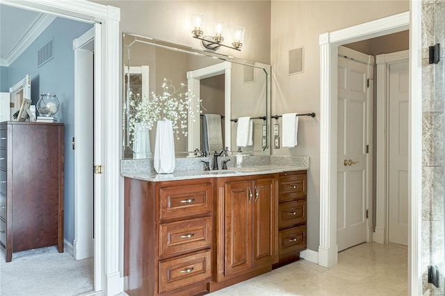 bathroom with crown molding, vanity, and visible vents