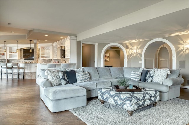 living area with recessed lighting and wood finished floors
