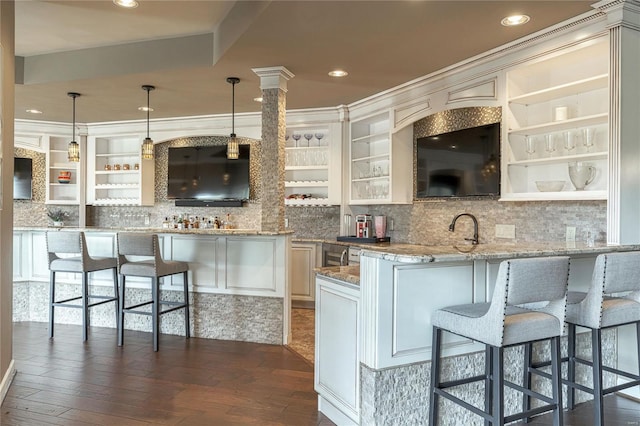 kitchen featuring backsplash, dark wood-style flooring, open shelves, and a kitchen bar