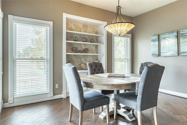 dining area with baseboards and wood finished floors