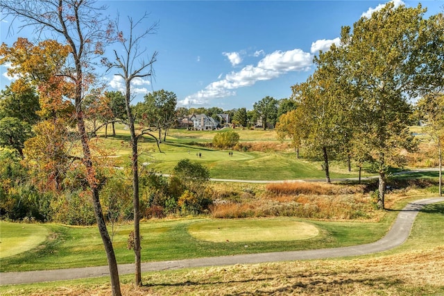 surrounding community featuring view of golf course and a yard