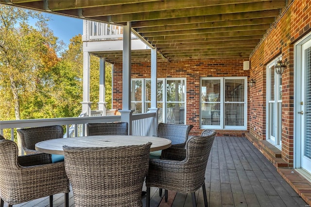 wooden terrace featuring outdoor dining space