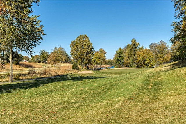 view of yard featuring a water view and view of golf course