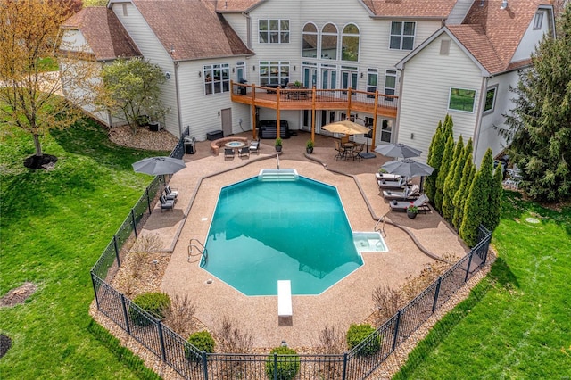 rear view of property featuring outdoor dining area, a fenced backyard, a wooden deck, and a yard