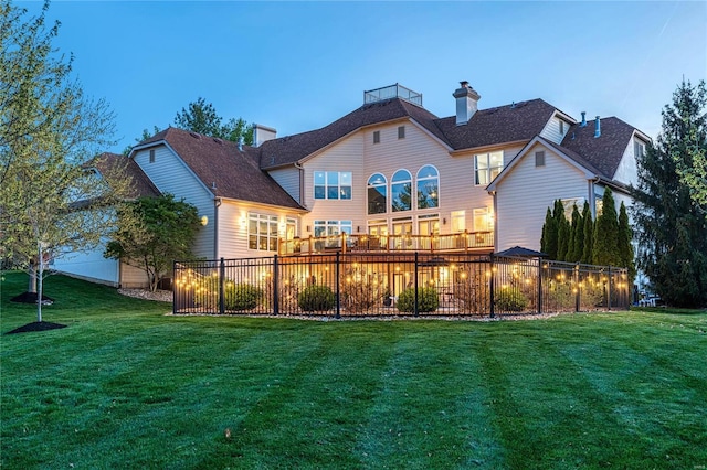 back of property with fence and a yard