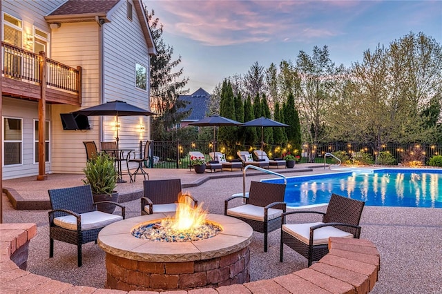 view of pool with a fenced in pool, a fire pit, a patio area, and fence