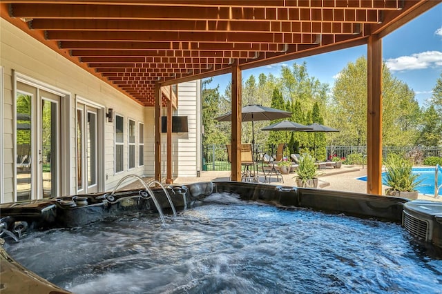 view of patio with a fenced in pool, a hot tub, and fence