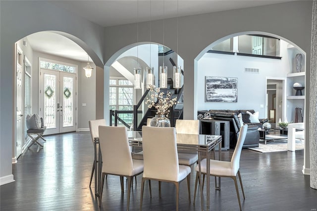 dining space featuring visible vents, dark wood-style flooring, baseboards, and french doors
