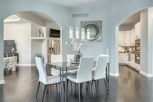 dining area with baseboards, dark wood finished floors, and visible vents