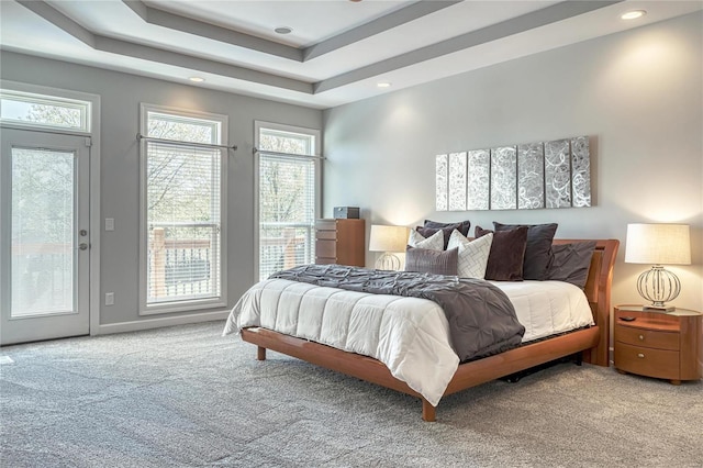 bedroom with a raised ceiling, access to outside, carpet, and recessed lighting