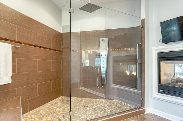bathroom with tile patterned floors and a stall shower
