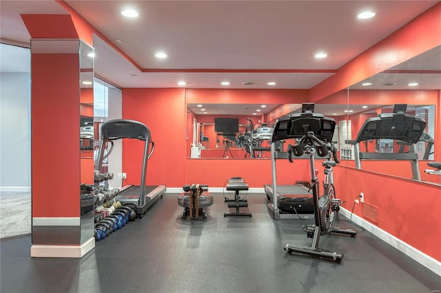 exercise room with recessed lighting and baseboards