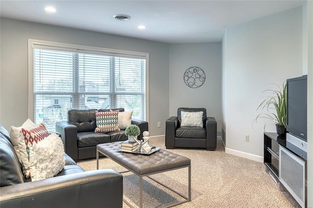 living room with visible vents, recessed lighting, baseboards, and light carpet