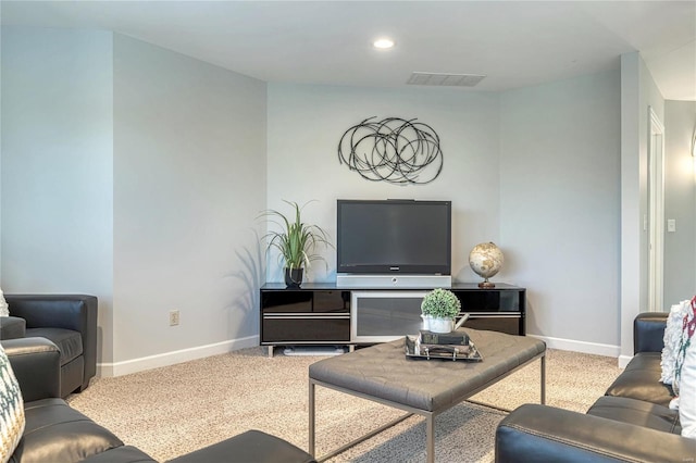 living room with visible vents, baseboards, and carpet floors