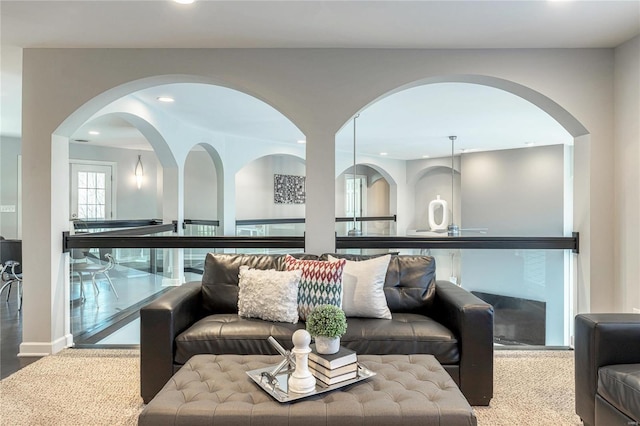 living area with arched walkways and recessed lighting