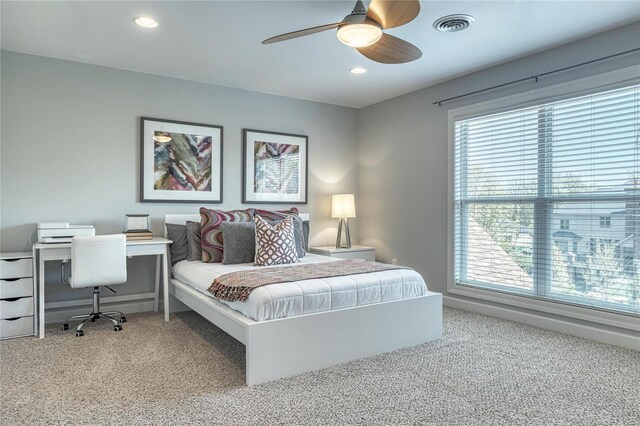 carpeted bedroom with multiple windows, recessed lighting, and visible vents