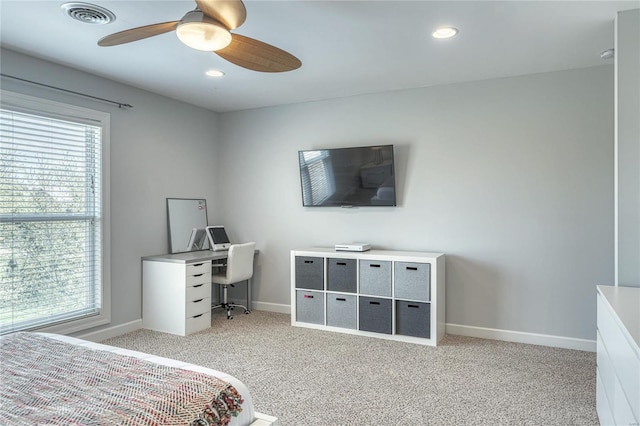 bedroom featuring visible vents, baseboards, multiple windows, and light colored carpet