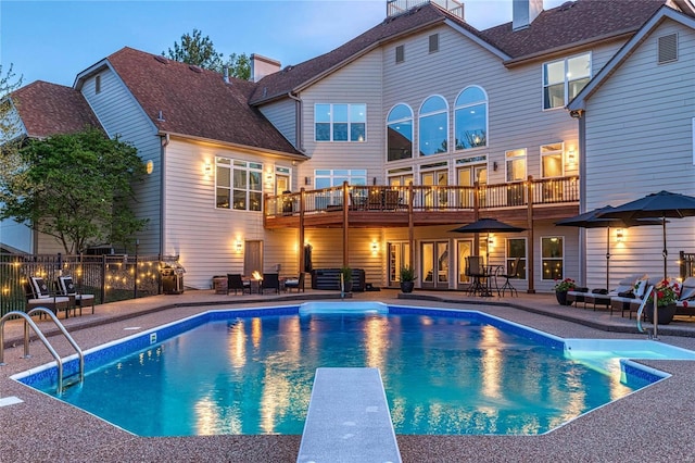 view of pool with a patio, a diving board, and a fenced in pool