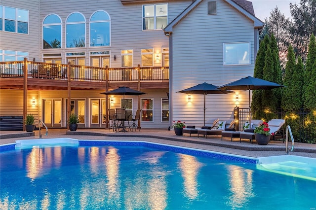 rear view of house featuring outdoor lounge area, an outdoor pool, and a patio area