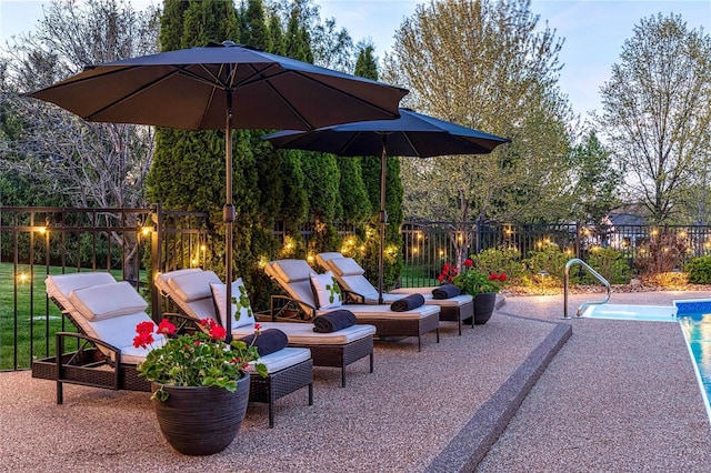 view of patio / terrace featuring outdoor lounge area, fence, and an outdoor pool