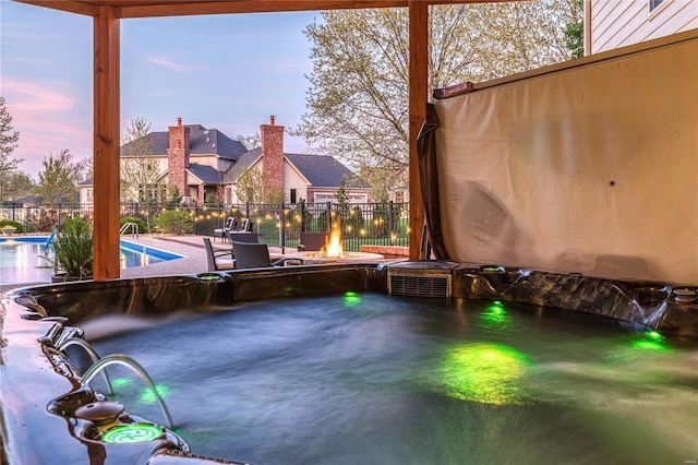 view of patio / terrace with fence, a fenced in pool, and an outdoor fire pit