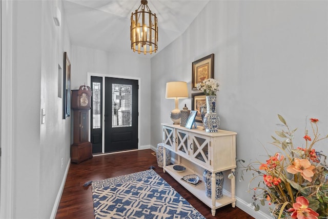 entryway featuring a chandelier, baseboards, and wood finished floors