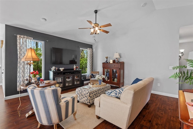 living room with a ceiling fan, wood finished floors, and a healthy amount of sunlight