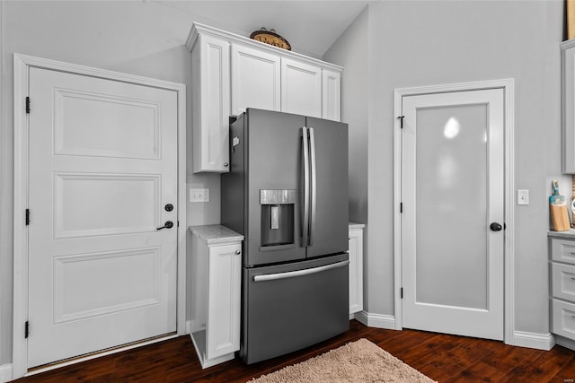kitchen featuring white cabinetry, baseboards, stainless steel fridge, and dark wood finished floors