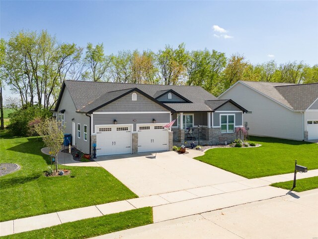 craftsman-style home featuring stone siding, driveway, a front lawn, and a garage