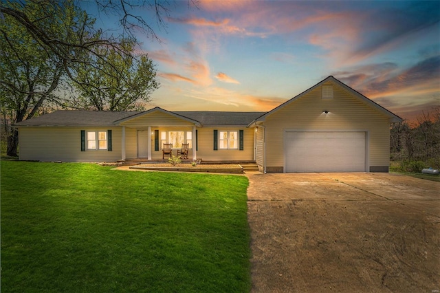 single story home featuring an attached garage, concrete driveway, and a front yard