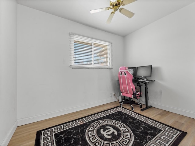 rec room with baseboards, a ceiling fan, and wood finished floors