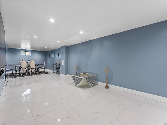 interior space featuring baseboards, recessed lighting, and marble finish floor