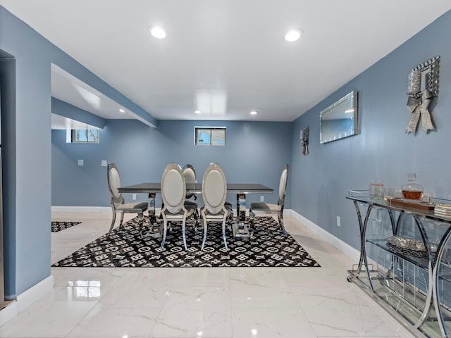 dining area with baseboards, recessed lighting, marble finish floor, and a healthy amount of sunlight