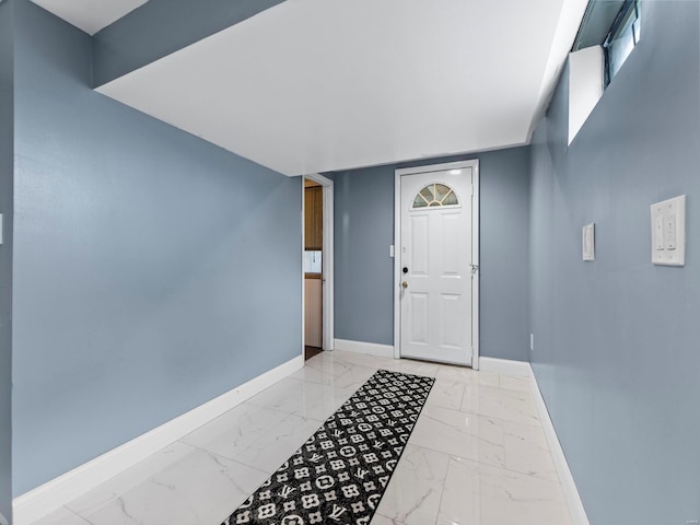 entryway featuring marble finish floor and baseboards